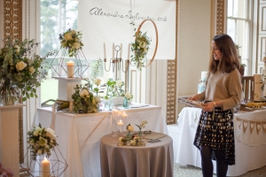 A young woman stands in front of a florist stall at the Bristol Wedding Show at Leigh Court