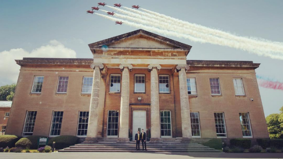 The red arrows fly over Leigh Court as a groom and groom pose in front of the mansion