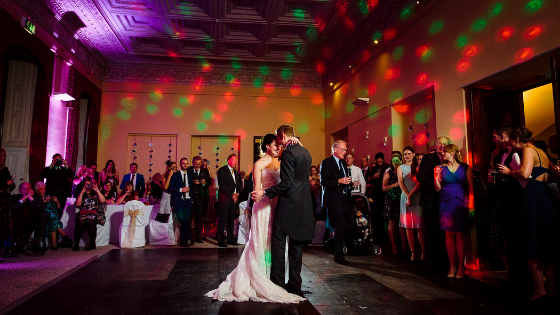 A wedding couple dance in the library at their Leigh Court wedding reception