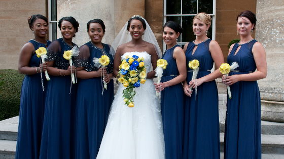 A bride and her bridesmaids on the steps of Leigh Court